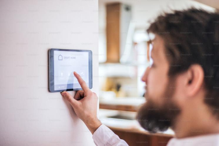 a person using smart home features through a tablet