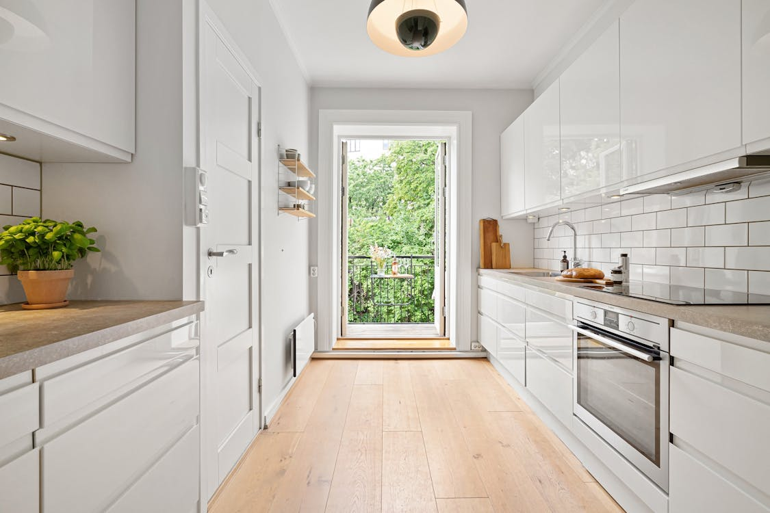 A kitchen with white cabinets