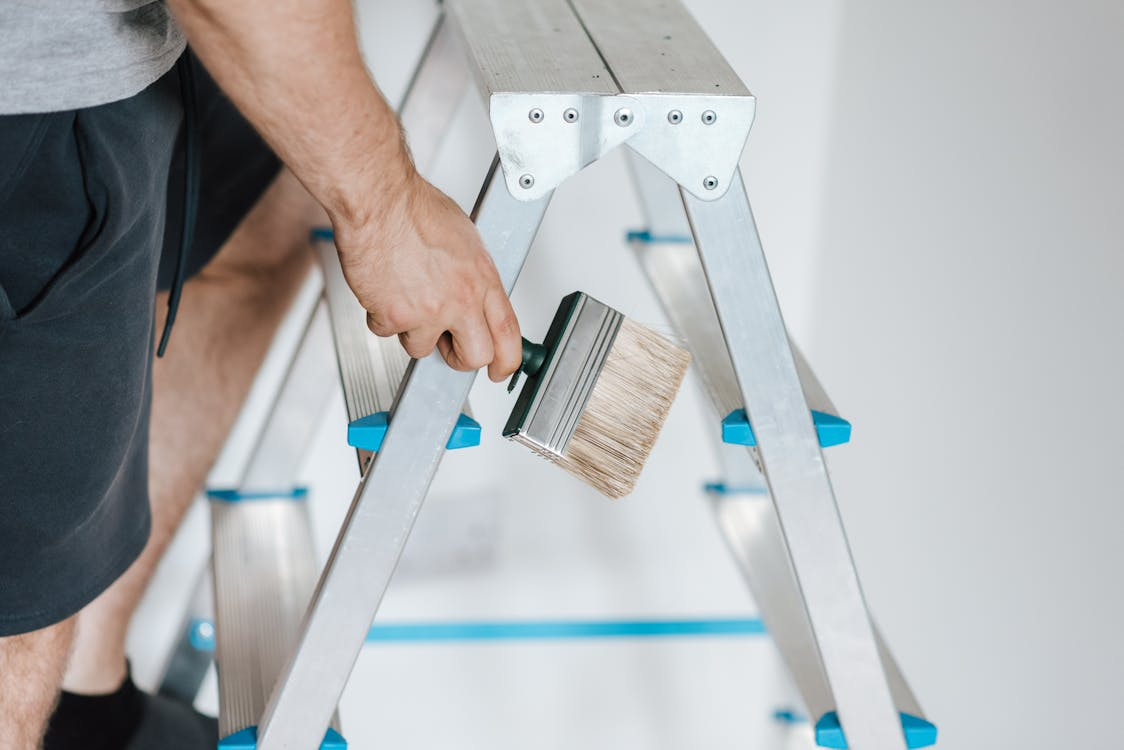 A painter climbing a ladder